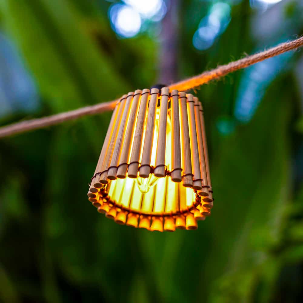 Illuminate your outdoor space with Okinawa Hang, a handmade bamboo pendant lamp with a convenient wireless, rechargeable bulb.